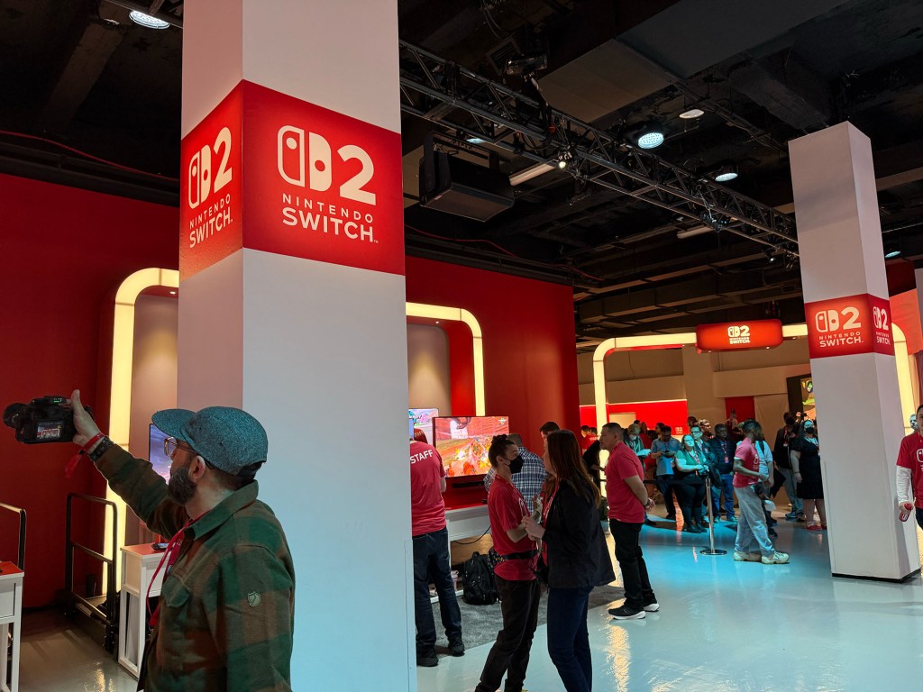 A group of people in a room with red and white objects