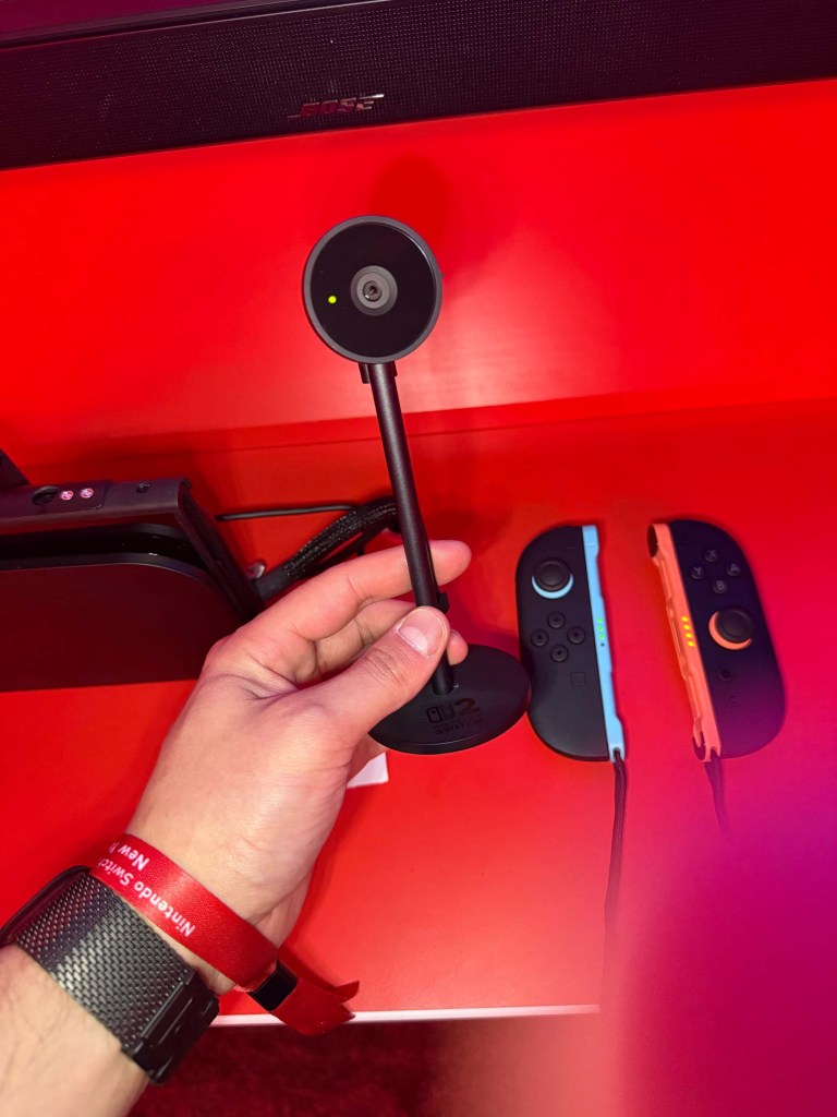 A hand holding a black object