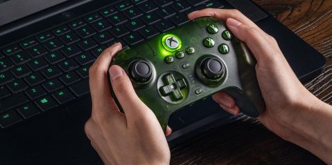 A person holding a gaming controller