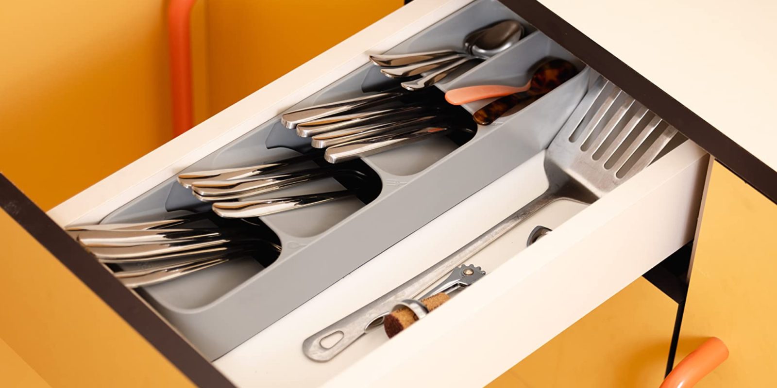A drawer with a variety of silverware in it