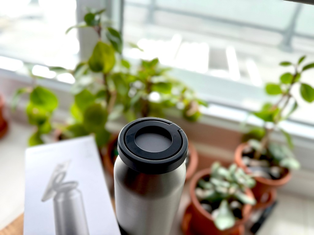 A silver and black bottle