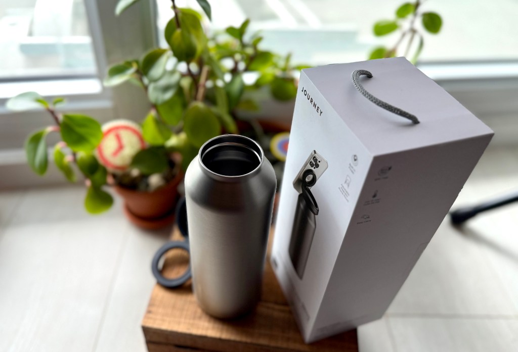 A silver bottle next to a box