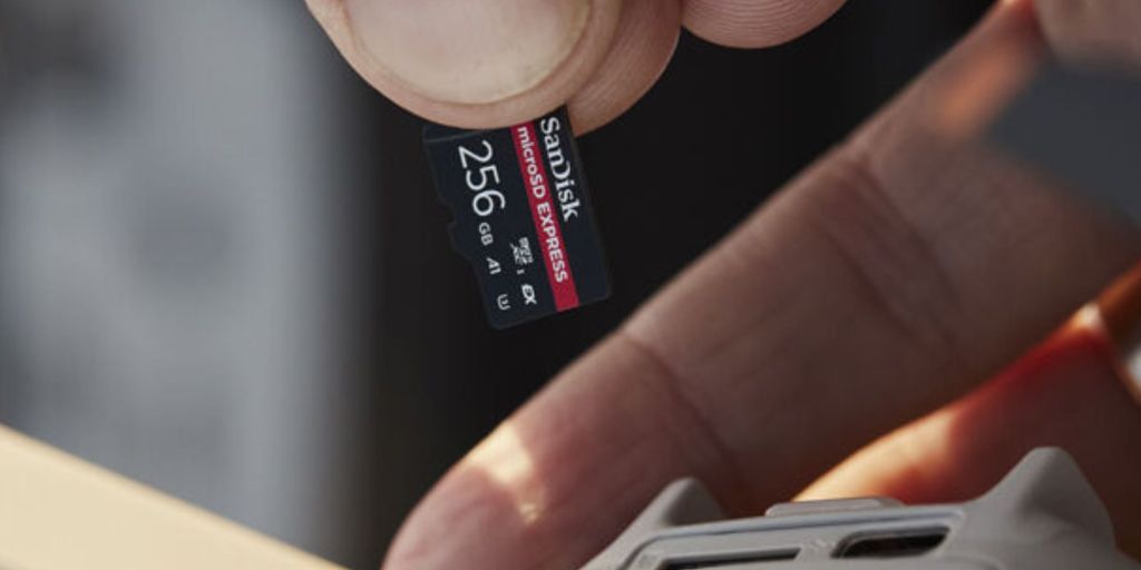 A hand holding a memory card