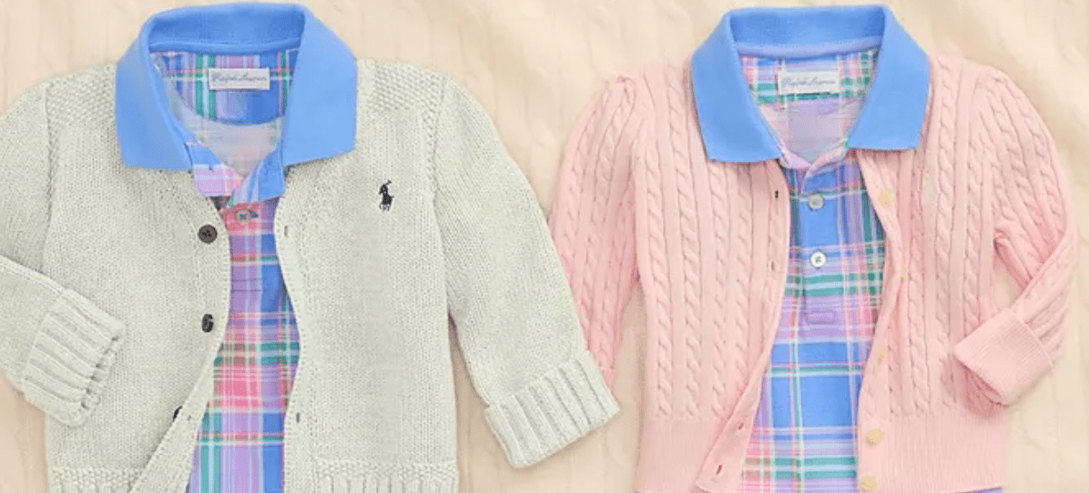 A couple of sweaters on a bed