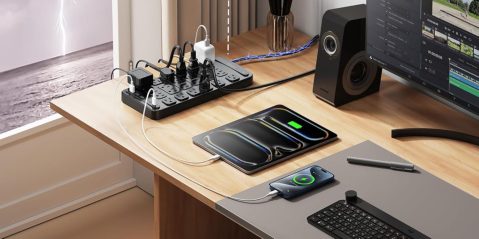 A table with a power strip and a phone