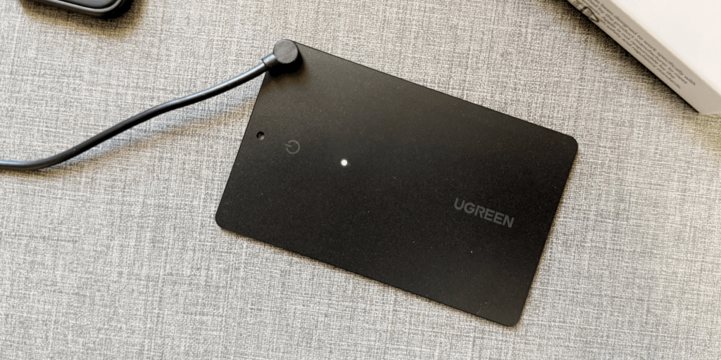 Image showing UGREEN's FineTrack Slim tracker connected to a charger.