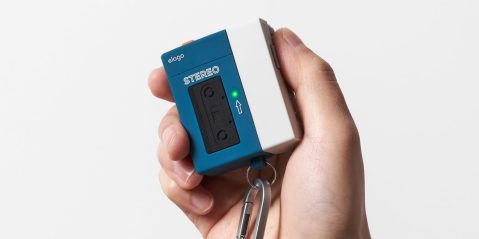 A hand holding a cassette player