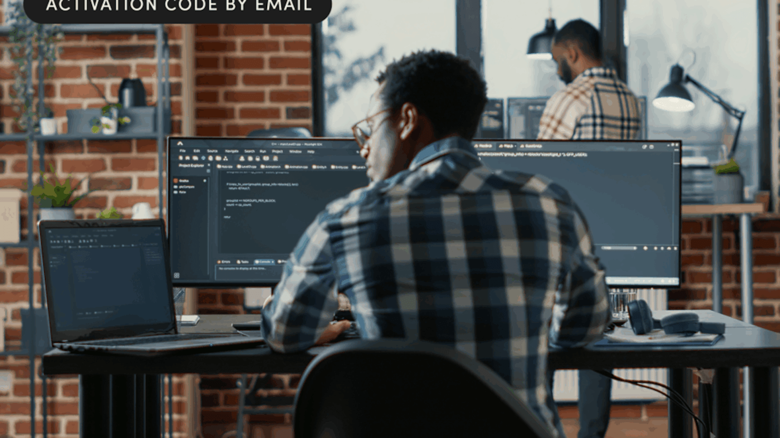 A man sitting at a desk with a computer
