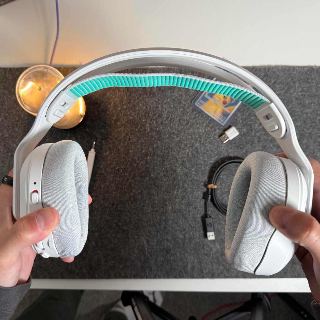 A pair of hands holding headphones