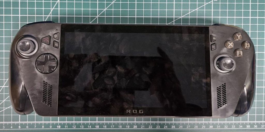 A rectangular black device with a square ruler on a green grid