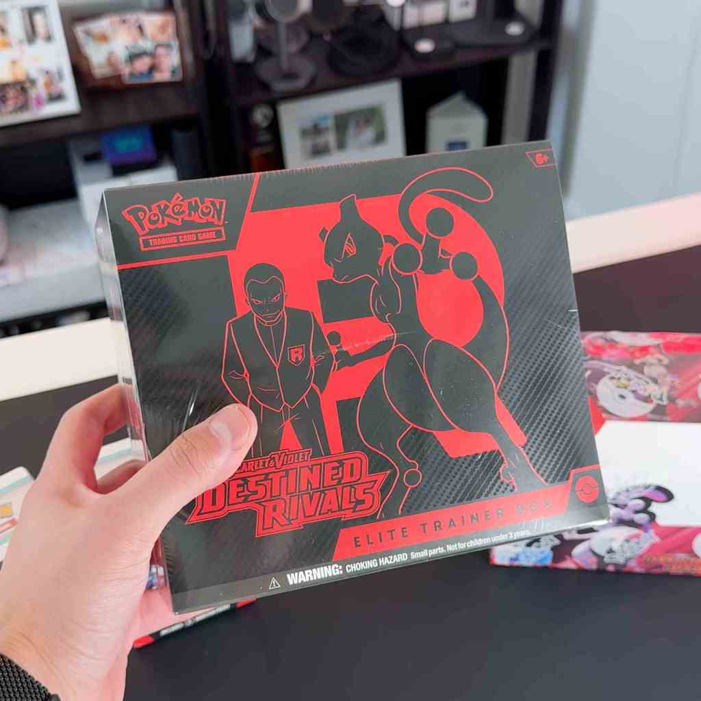 A hand holding a box with a cartoon character on it