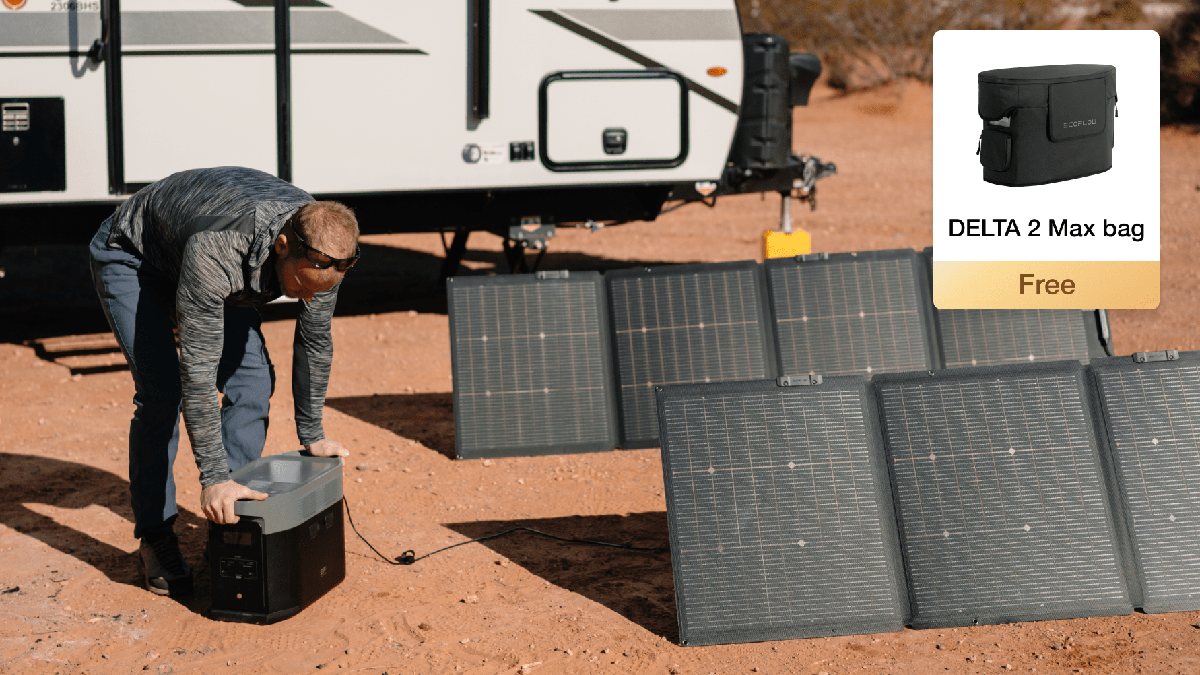 A man standing near solar panels