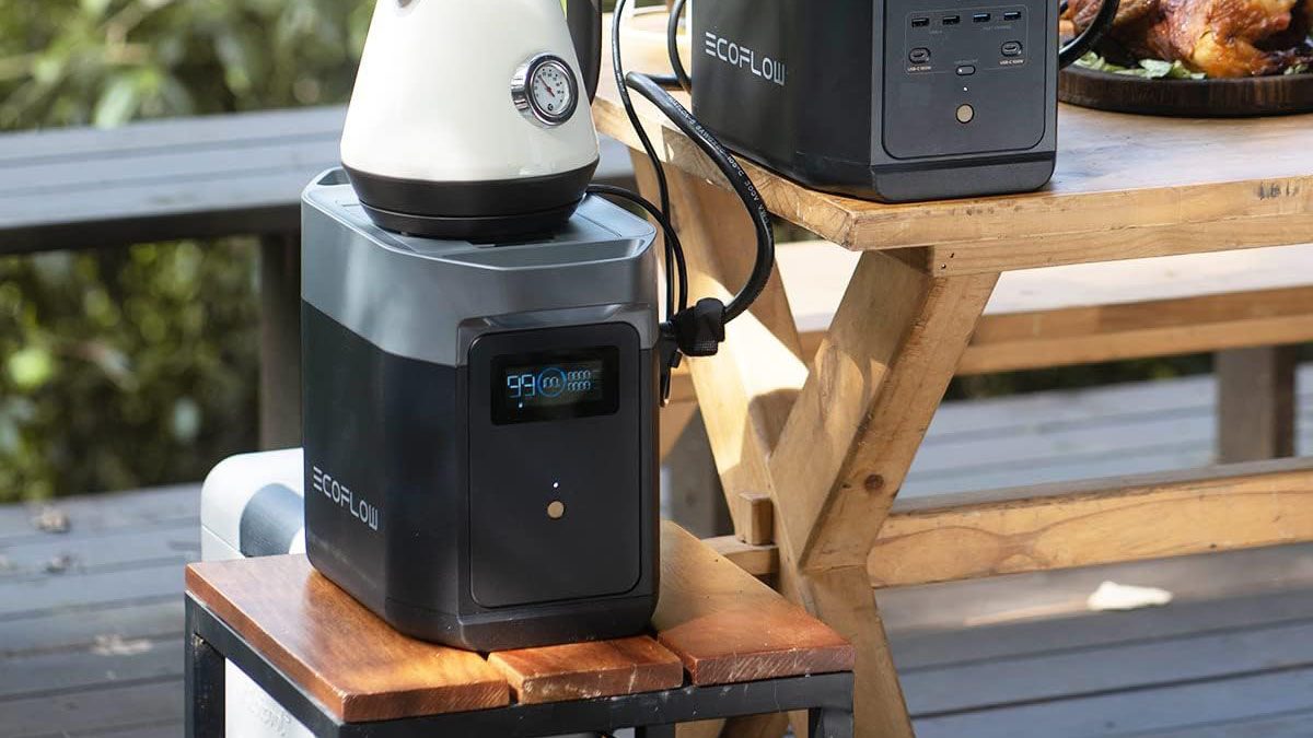 A white and black machine on a wooden table