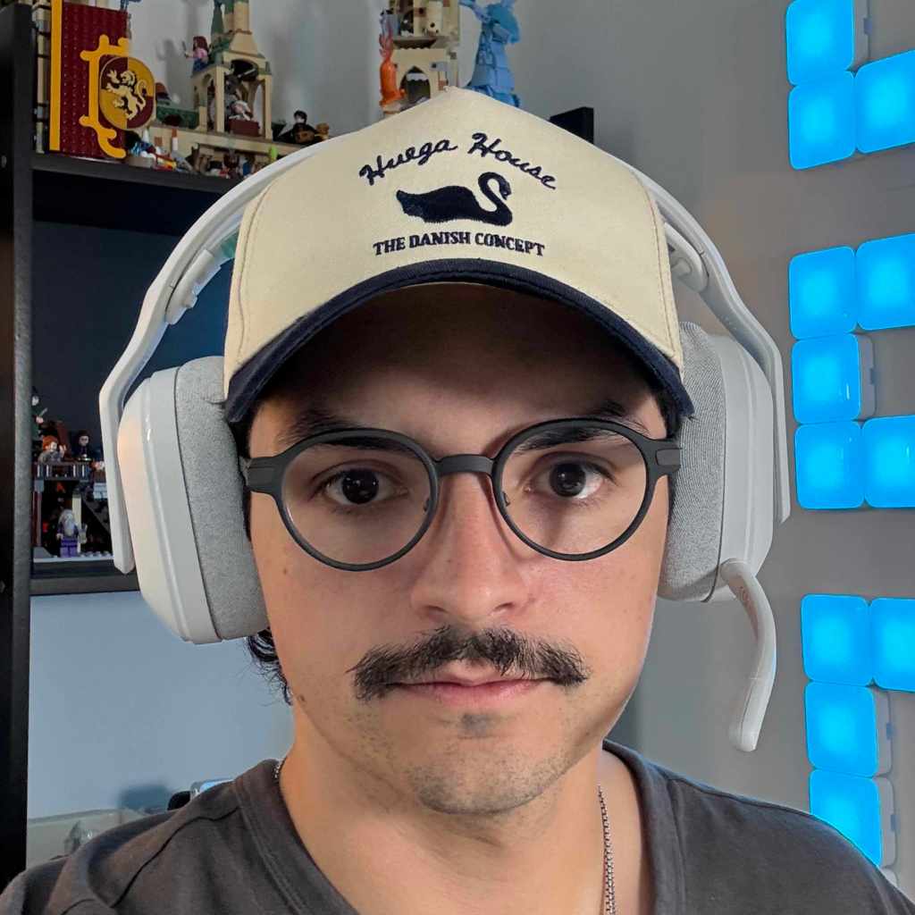 A man wearing glasses and a hat with headphones