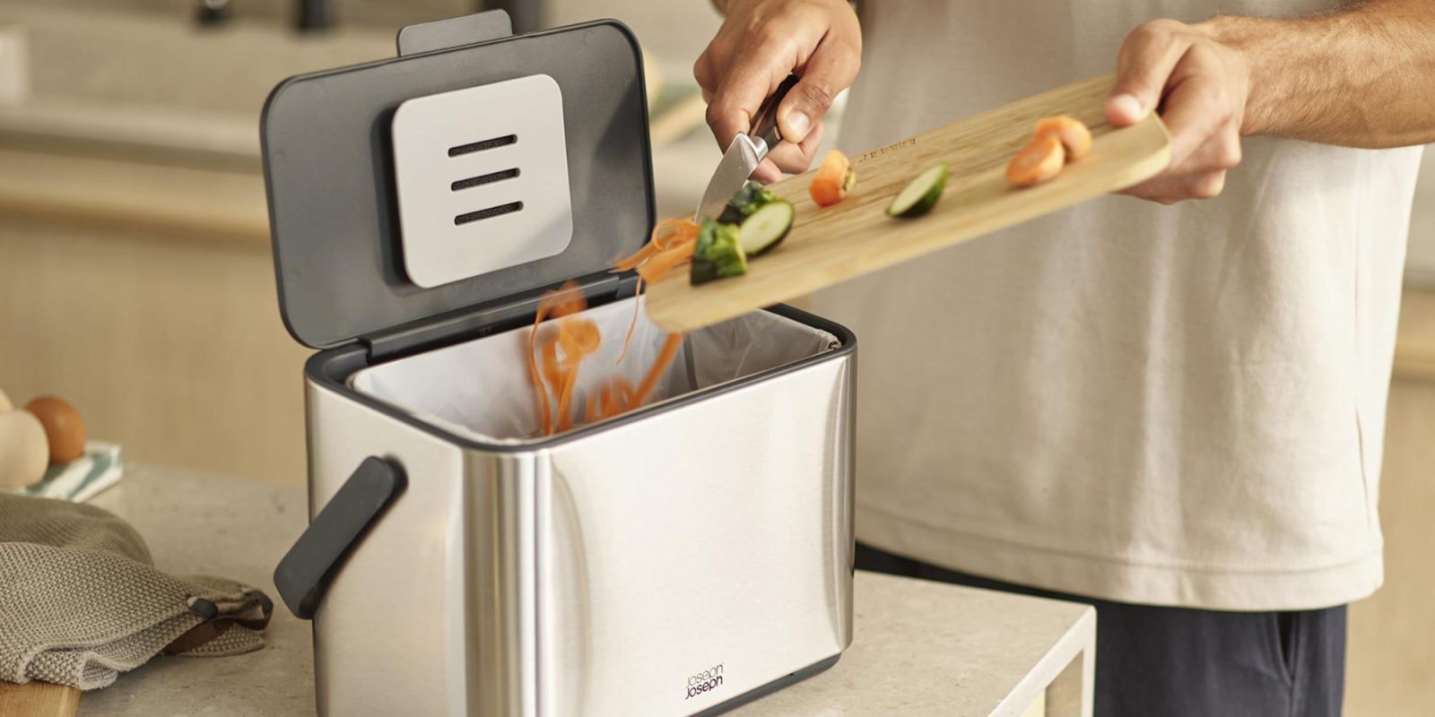 A person cutting vegetables into a toaster