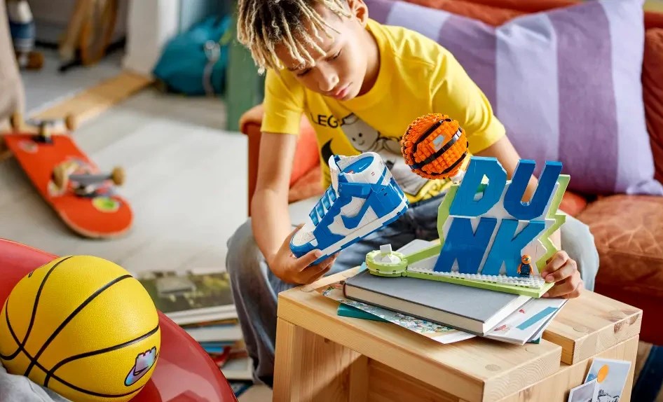 A boy playing with LEGO Nike Dunk set