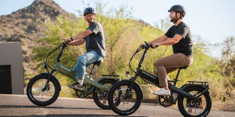 Two men riding bicycles on a road