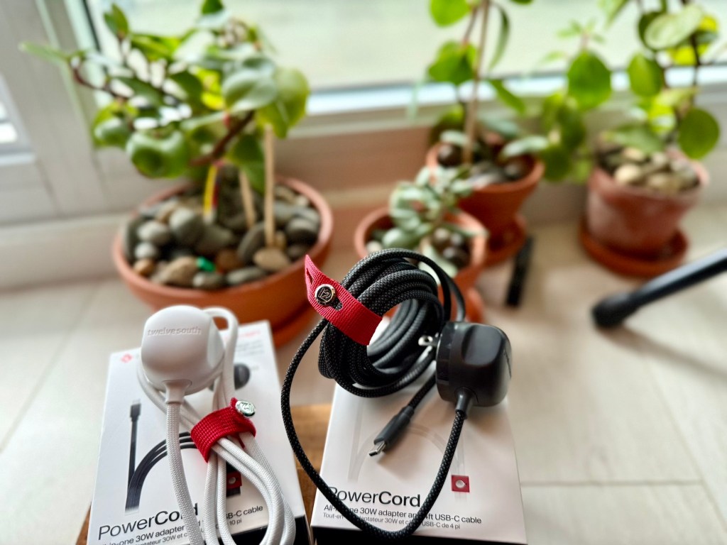 A pair of ear buds and a box with a cord