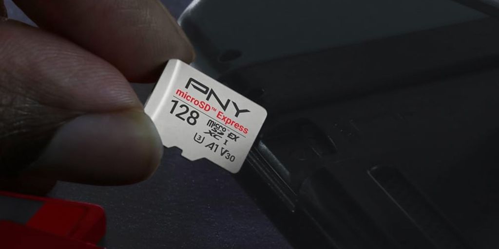 A hand holding a memory card