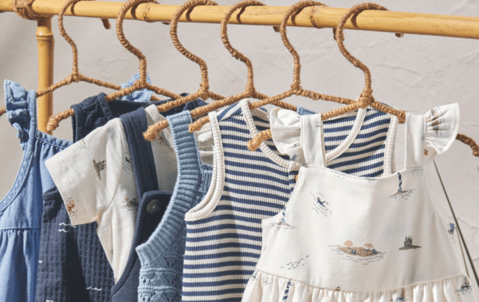 A group of baby clothes on swingers