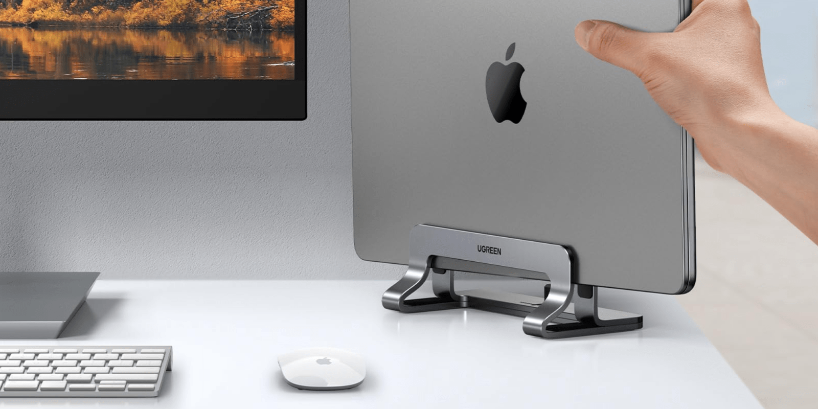 A hand pointing at a computer monitor