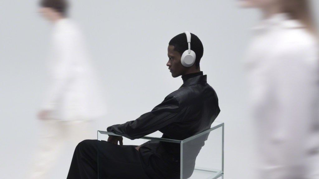 A man wearing headphones sitting in a chair