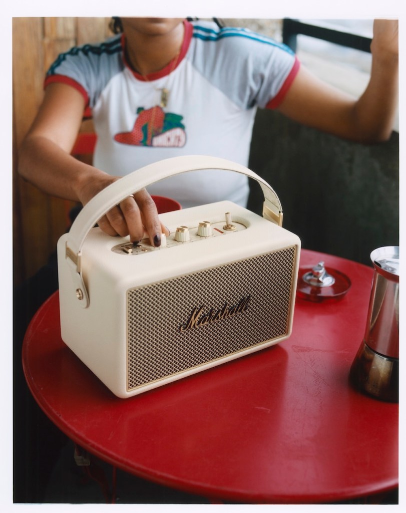 A woman holding a speaker