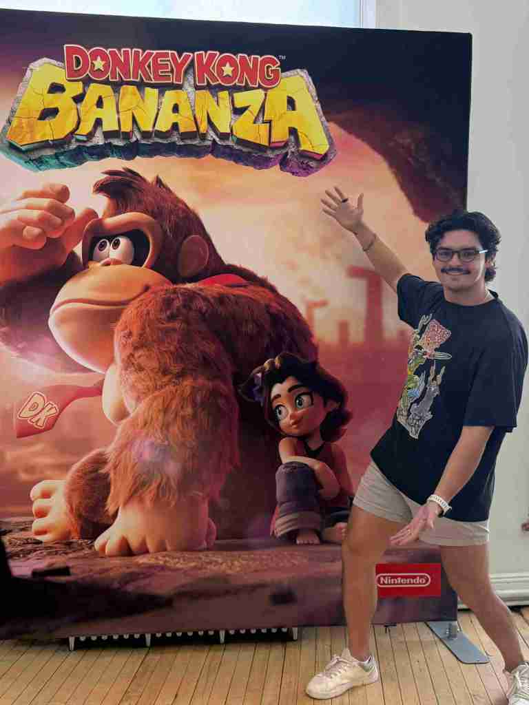 A man standing in front of a poster