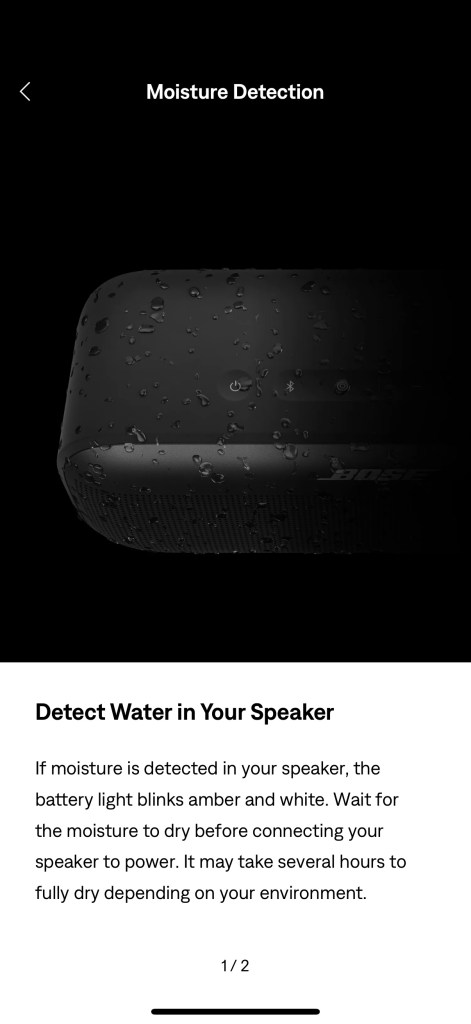 A black speaker with water drops on it