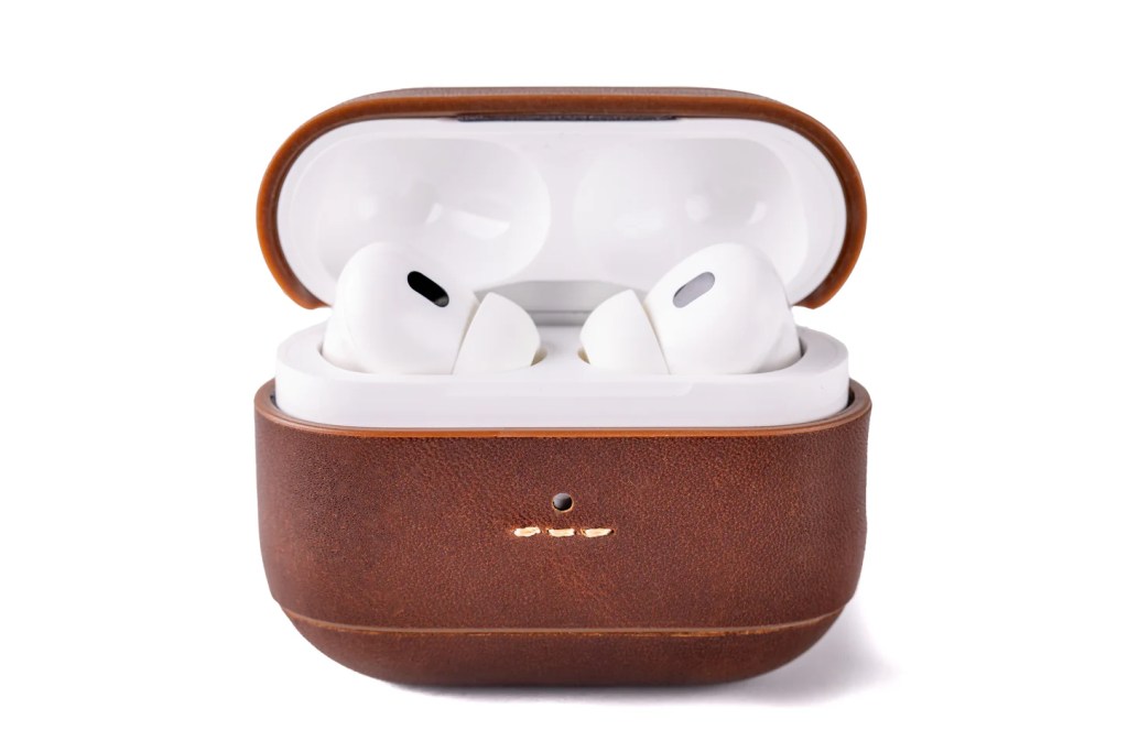 A white earbuds in a brown case