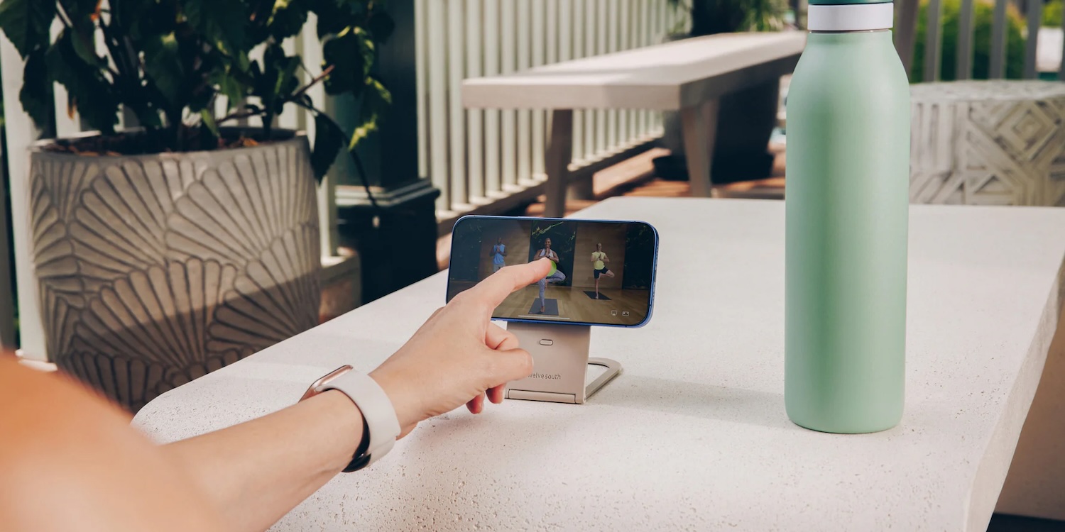 A person's hand pointing at a phone screen