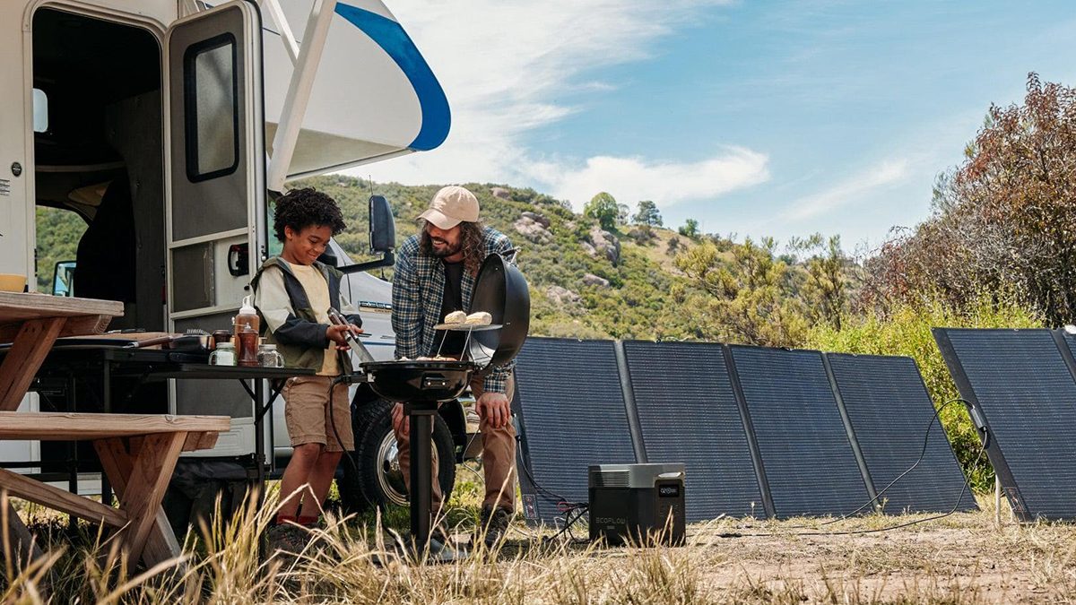 A man and boy cooking food on a grill