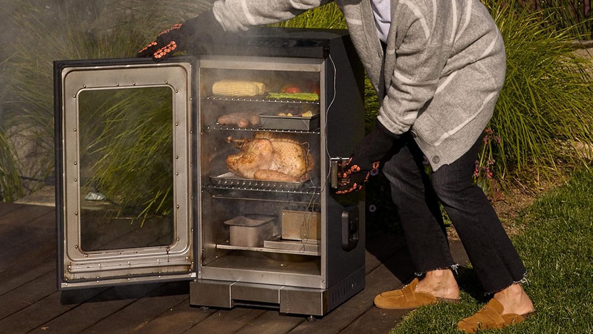 A man putting food into an open oven
