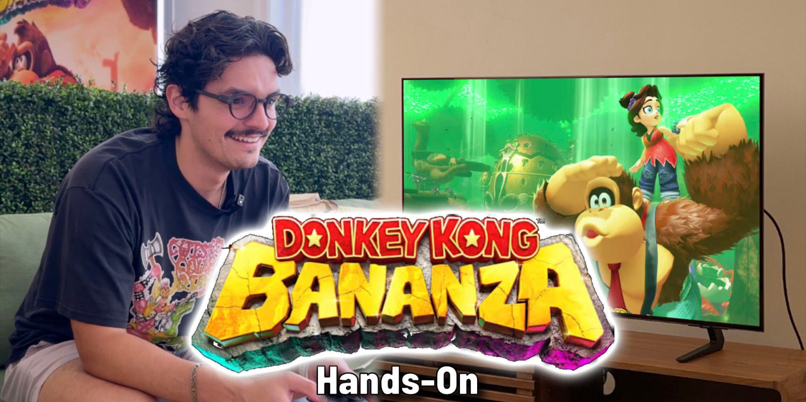 A man smiling and holding a video game