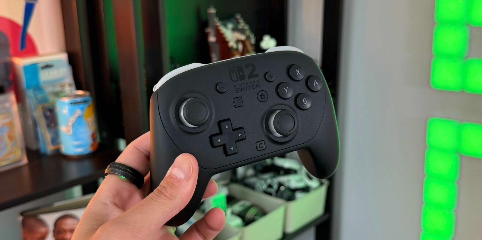 A hand holding a video game controller