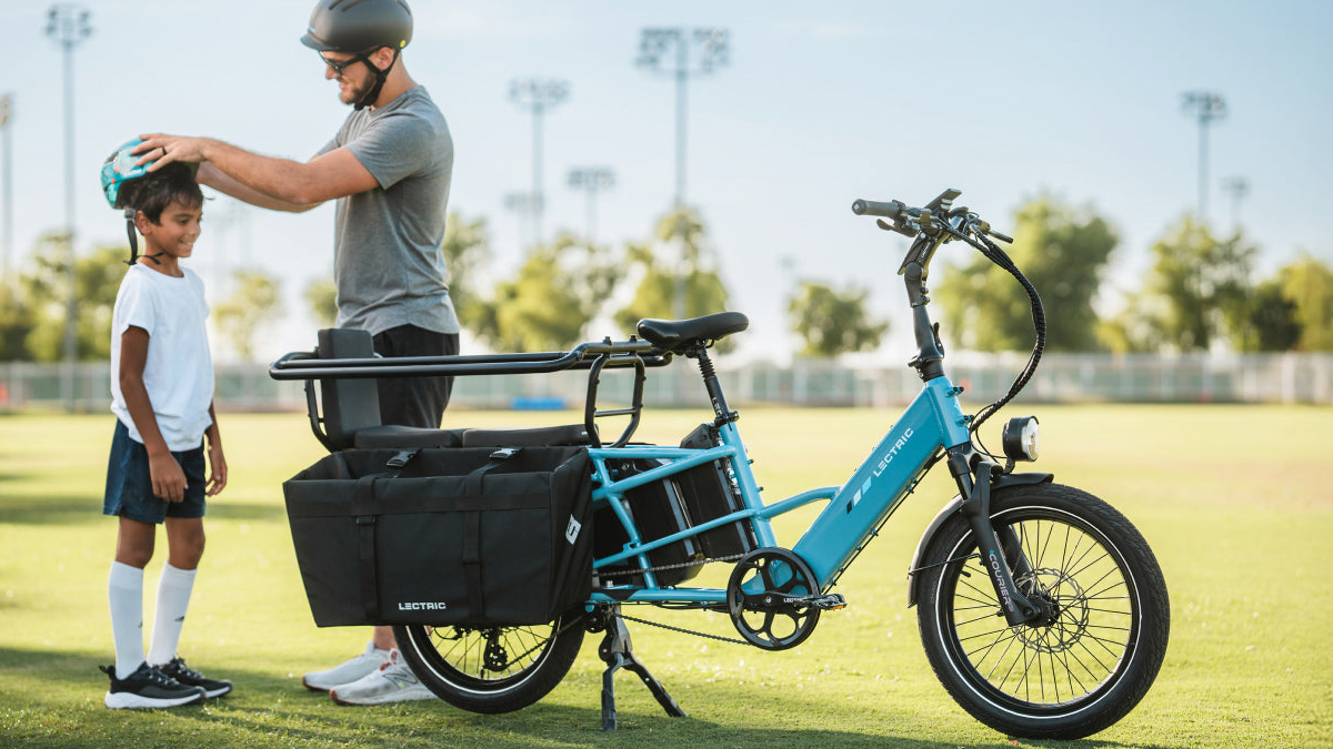A man standing next to a bicycle
