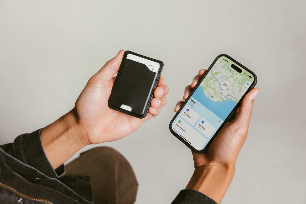 A pair of hands holding cell phones