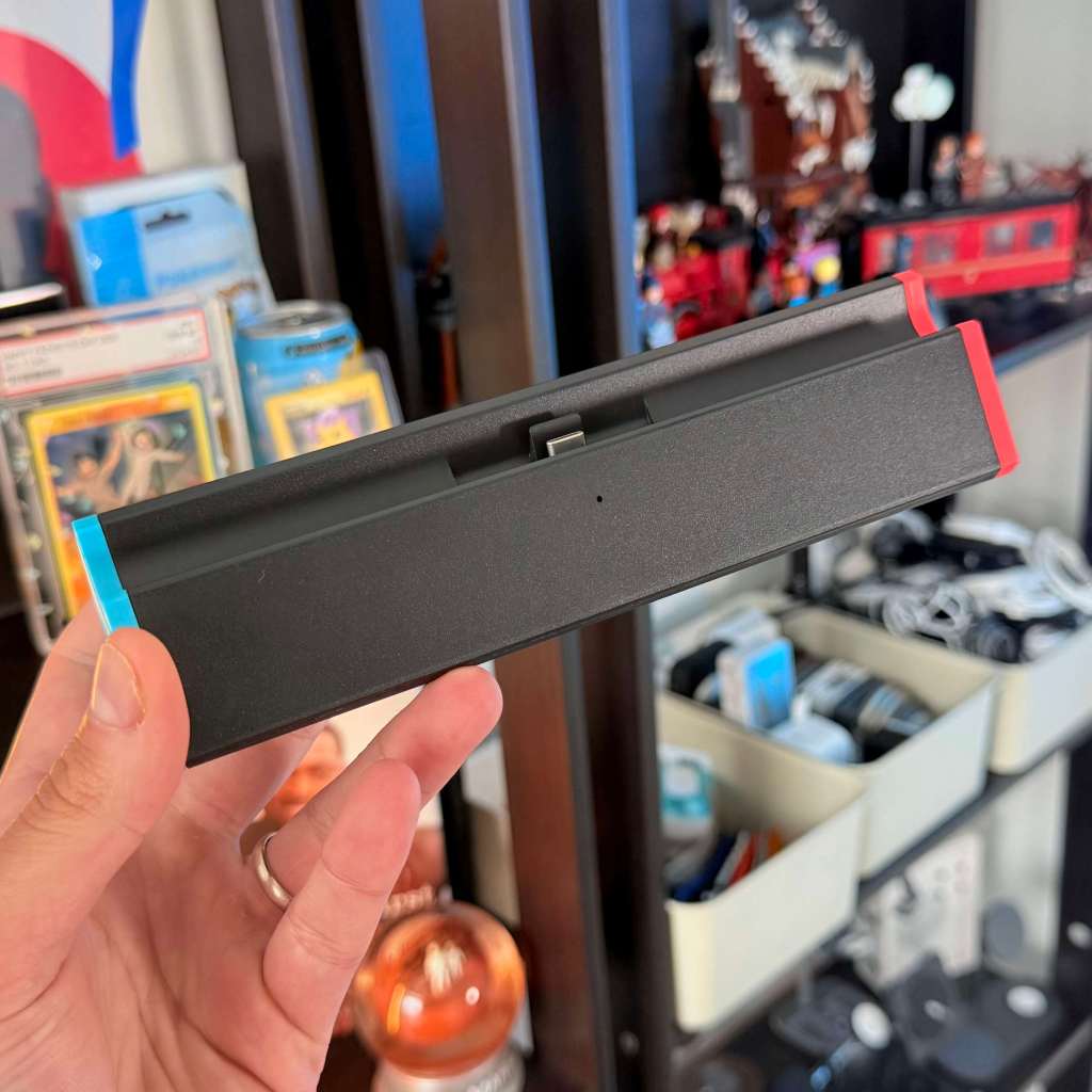 A hand holding a black rectangular object