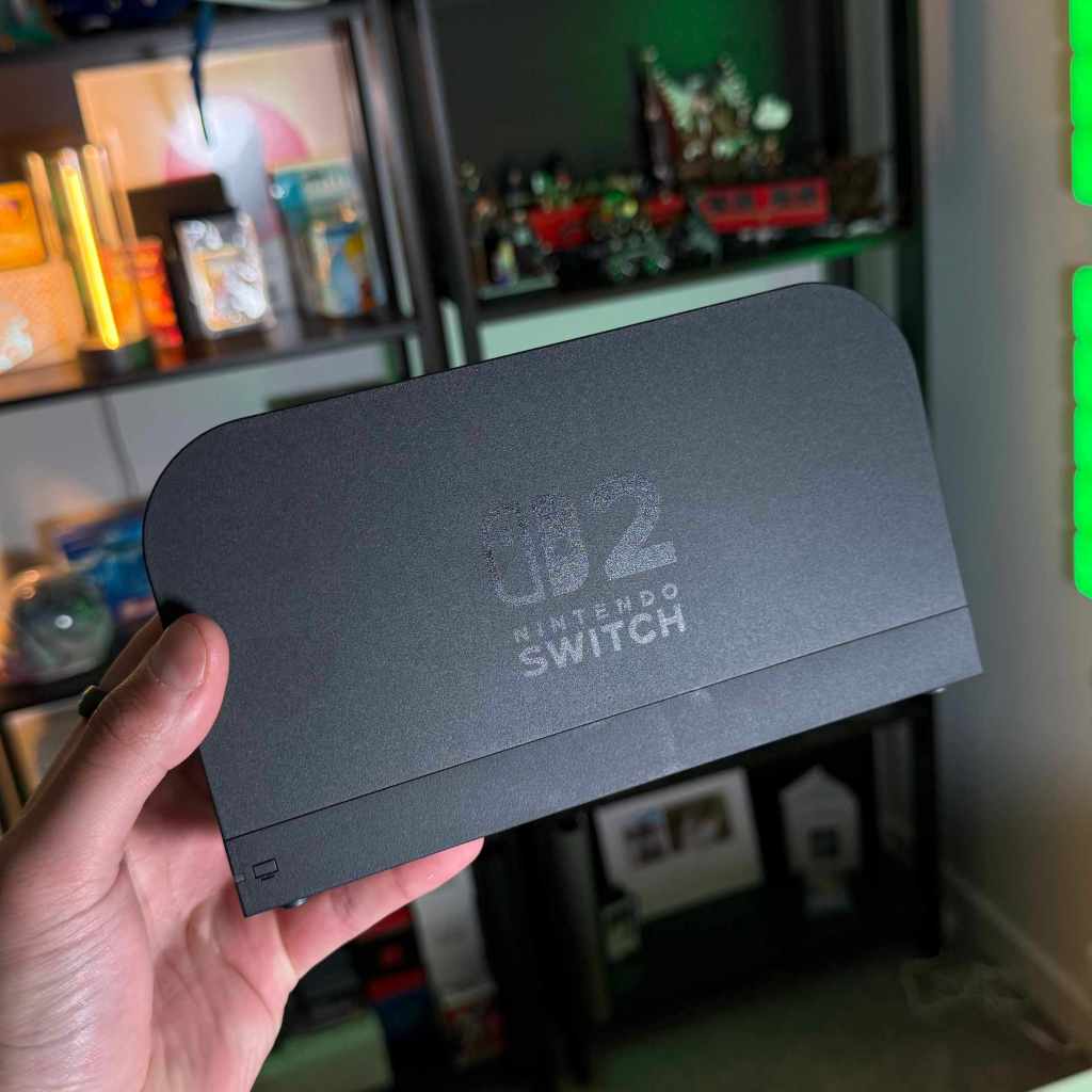 A hand holding a black rectangular object