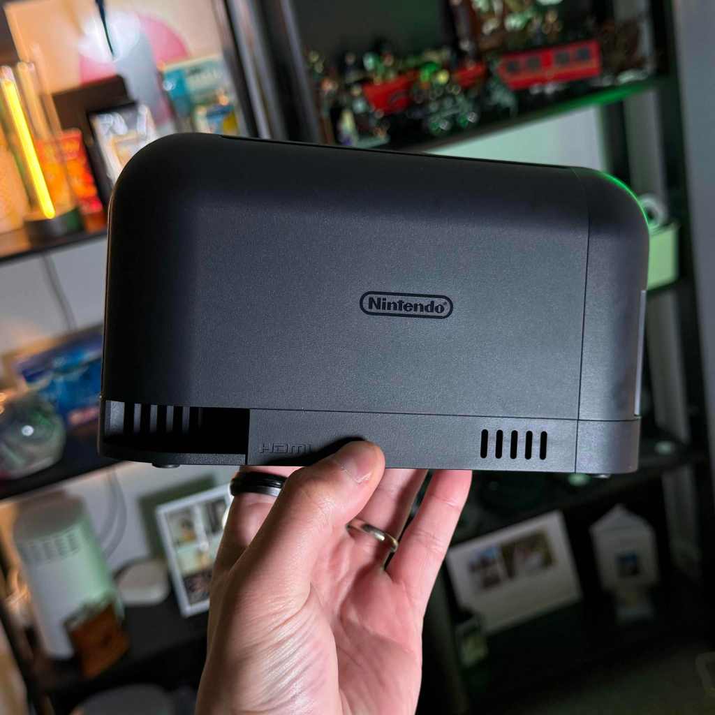 A hand holding a gaming device