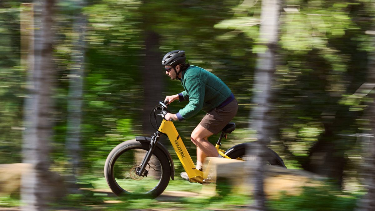 A man riding a yellow bike