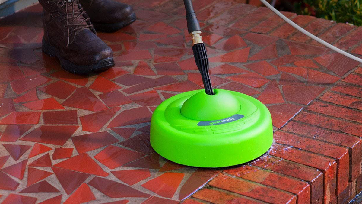 A green circular object with a black hose in it