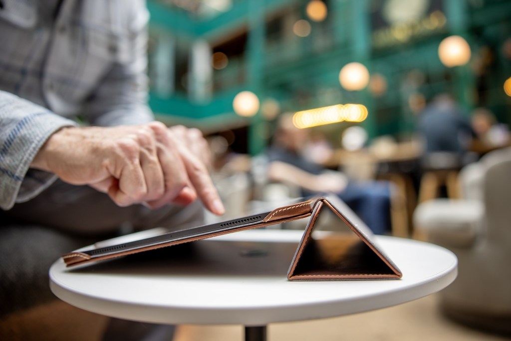 A person pointing at a tablet