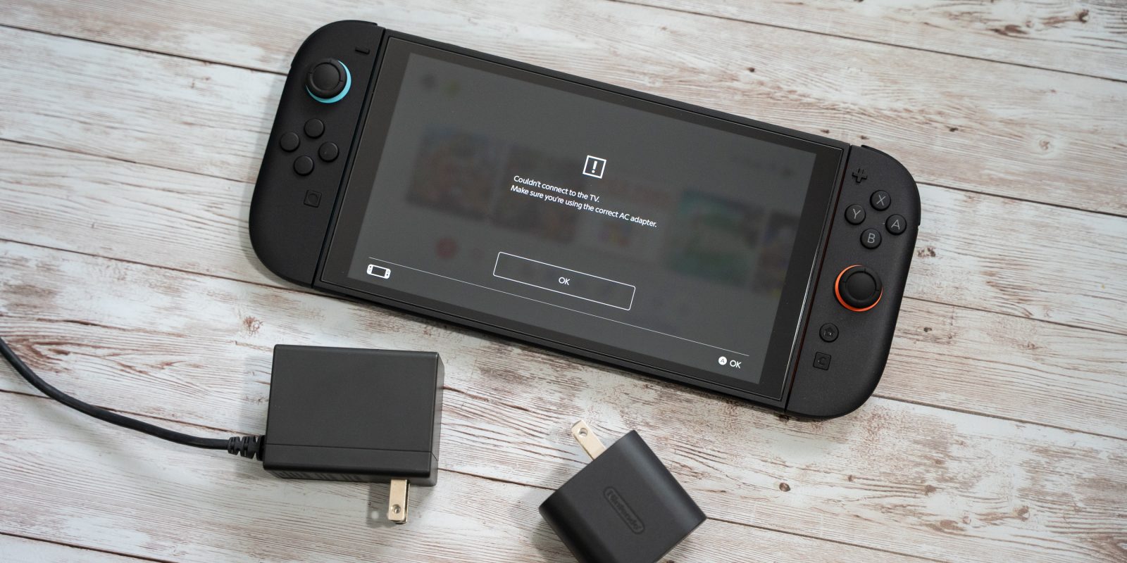 A black gaming device with a battery and charger