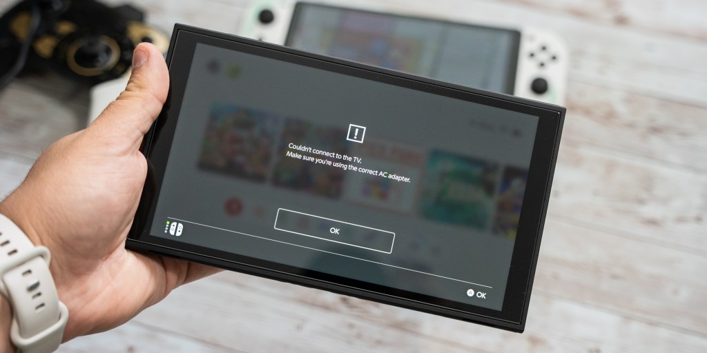 A hand holding a rectangular device