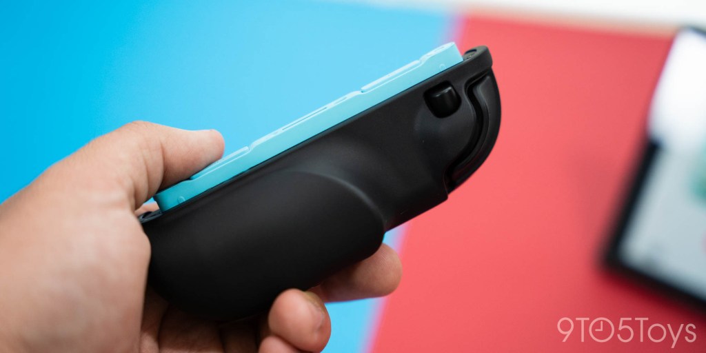 A hand holding a remote control