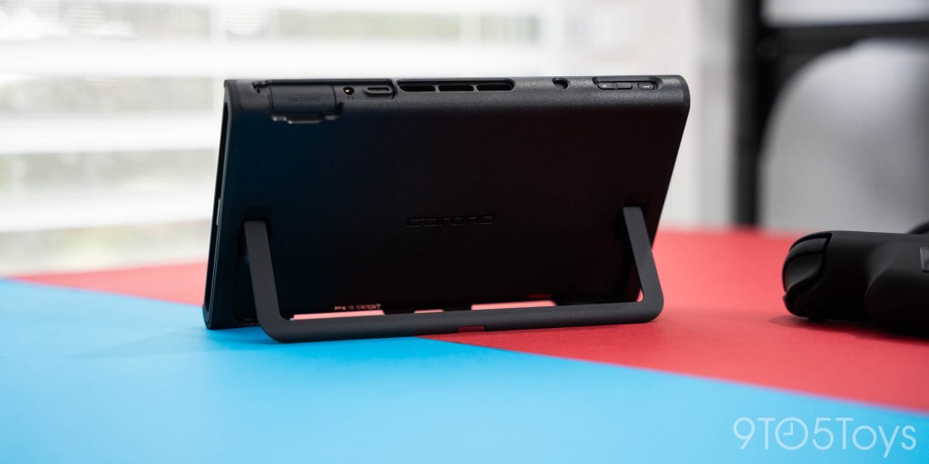 A black rectangular device on a blue and red surface