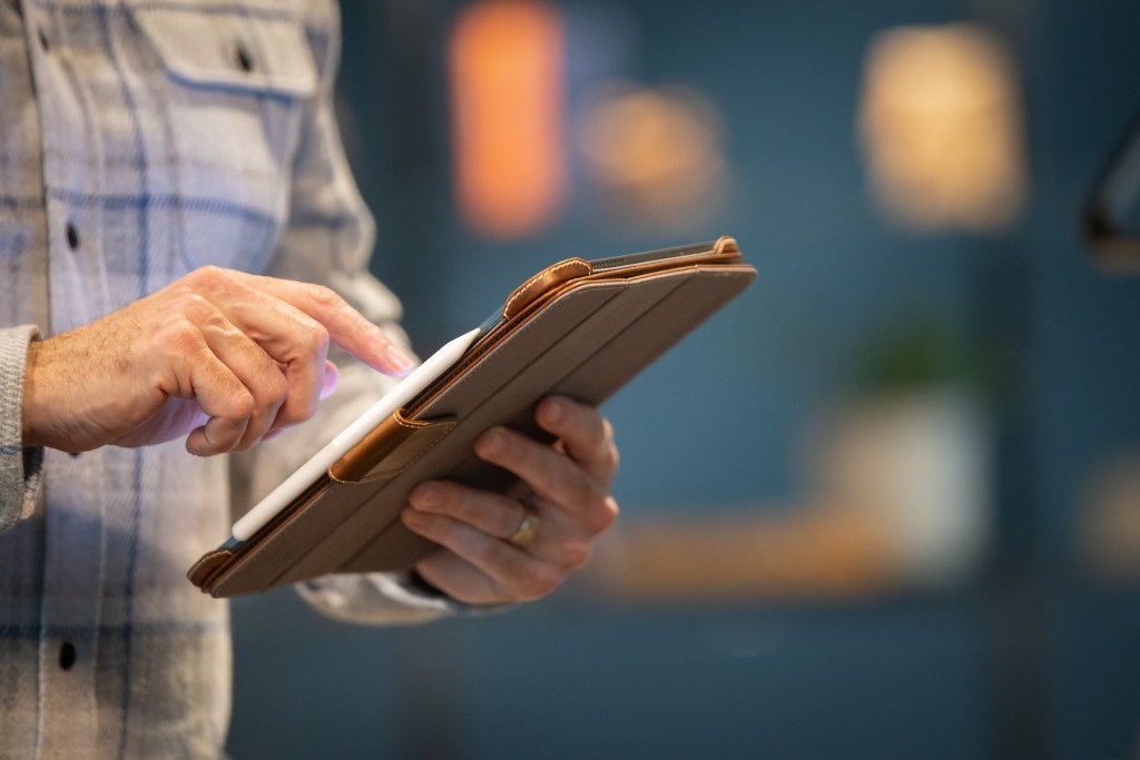 A person holding a tablet