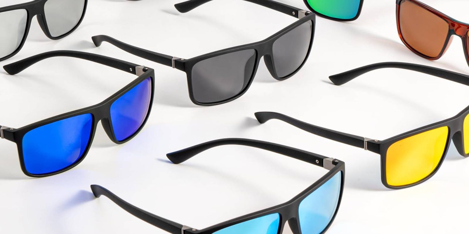 A group of sunglasses on a white surface