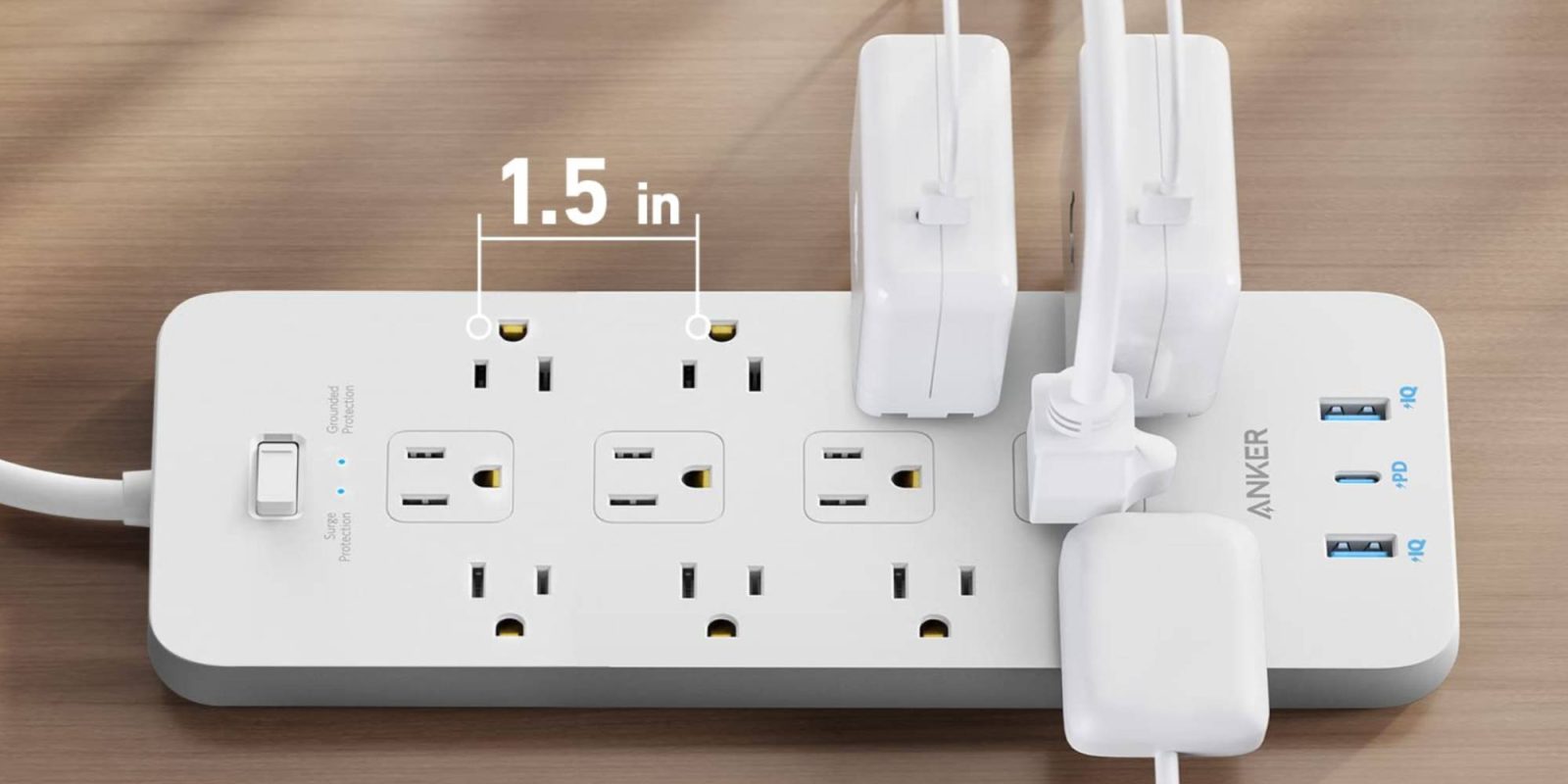 A white electrical outlet with plugs and cords